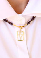 pendentif octogonale avec le mot Joy ajouré
